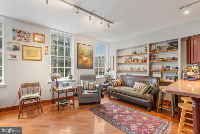 a bedroom with furniture a rug and a window