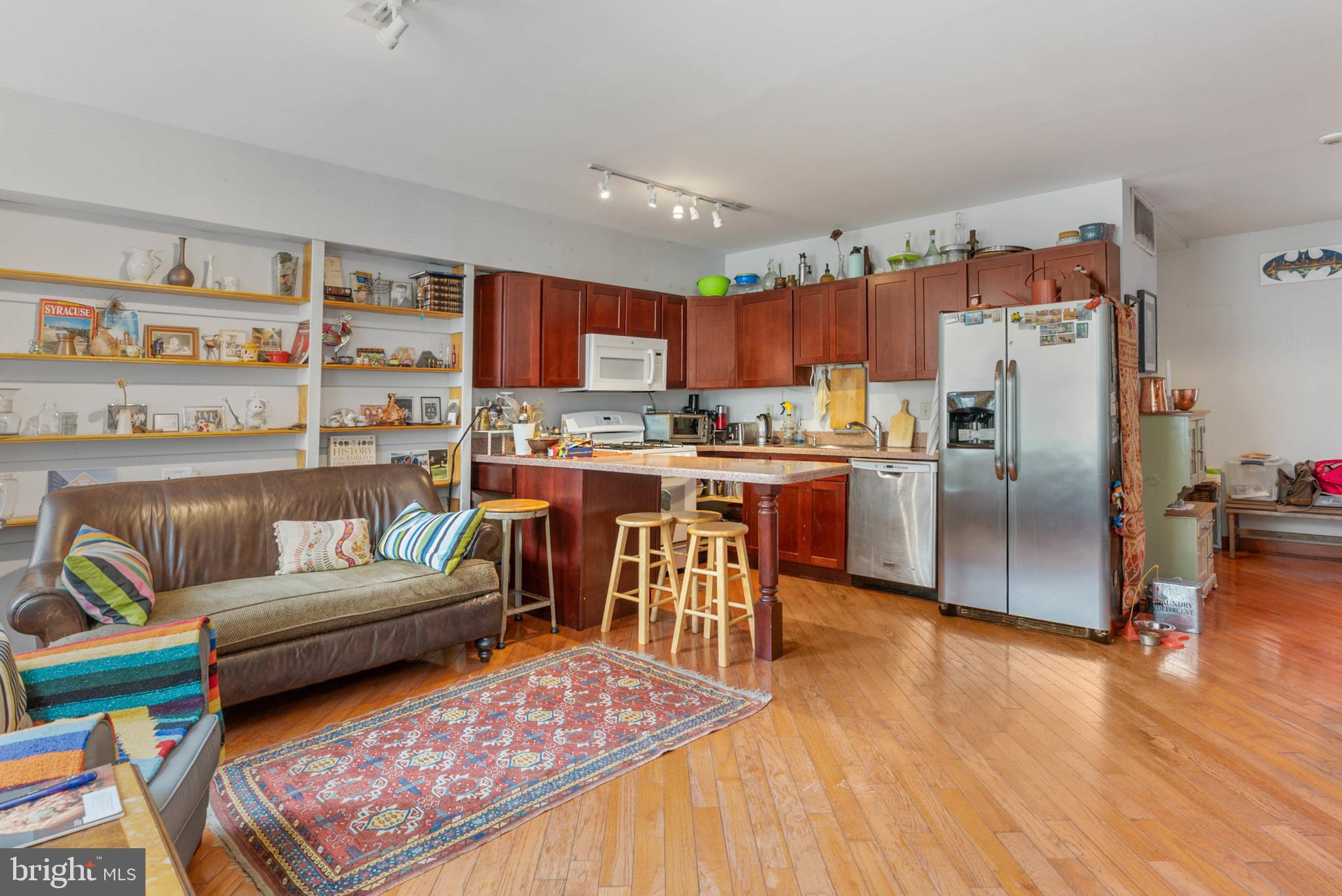 105 South 2nd Street Philadelphia, PA 19106 - Photo 35 of 54 a living room with stainless steel appliances furniture a rug and a kitchen view