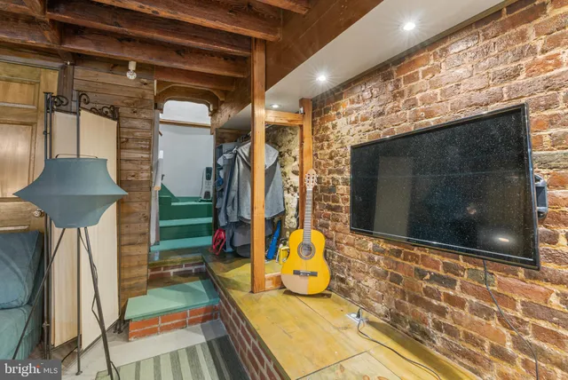 a living room with patio furniture and a fireplace