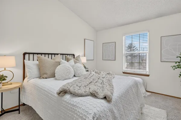 a large white bed in a white room