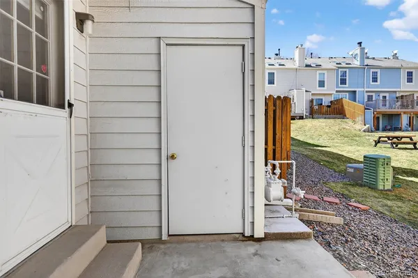 a view of a house with wooden fence