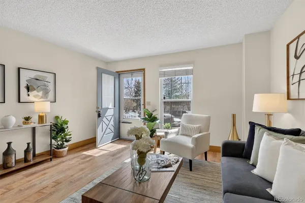 a living room with furniture and wooden floor