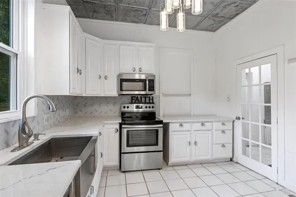a kitchen with cabinets appliances and a sink