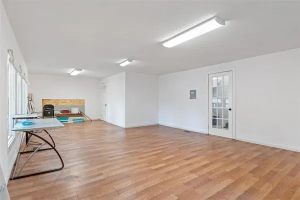 a view of a room with wooden floor and workspace