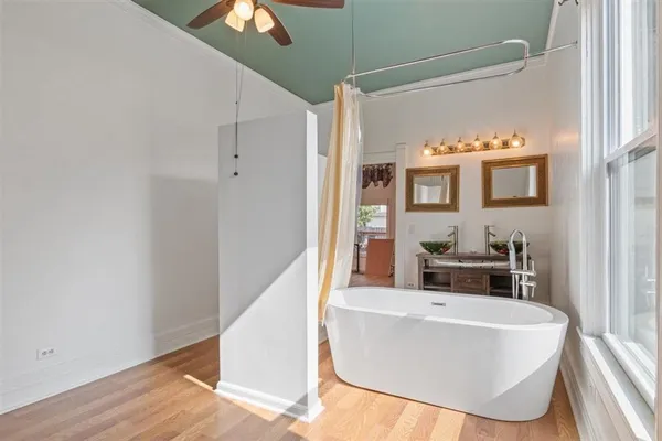 a bathroom with a sink a mirror and a bath tub