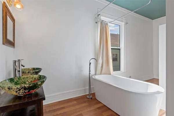 a view of a room that has a couch and a potted plant