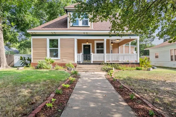 a front view of a house with a yard and porch