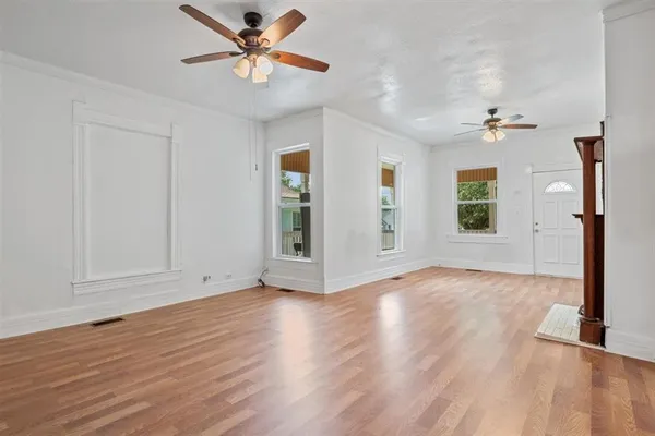 wooden floor in an empty room with a window
