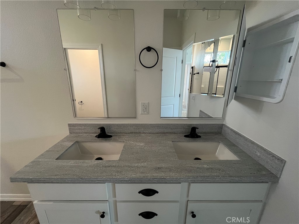 1550 Rimpau Avenue, Unit 42 Corona, CA 92881 - Photo 19 of 22 a bathroom with a sink and a mirror