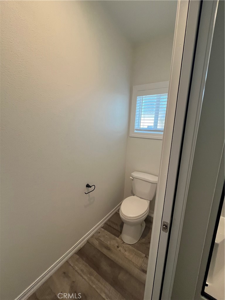 1550 Rimpau Avenue, Unit 42 Corona, CA 92881 - Photo 20 of 22 a bathroom with a granite countertop toilet and a sink
