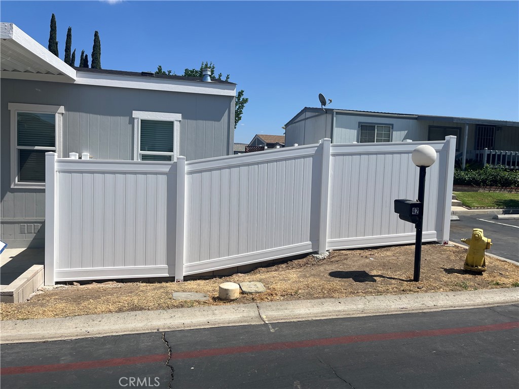 1550 Rimpau Avenue, Unit 42 Corona, CA 92881 - Photo 21 of 22 a view of a house with backyard
