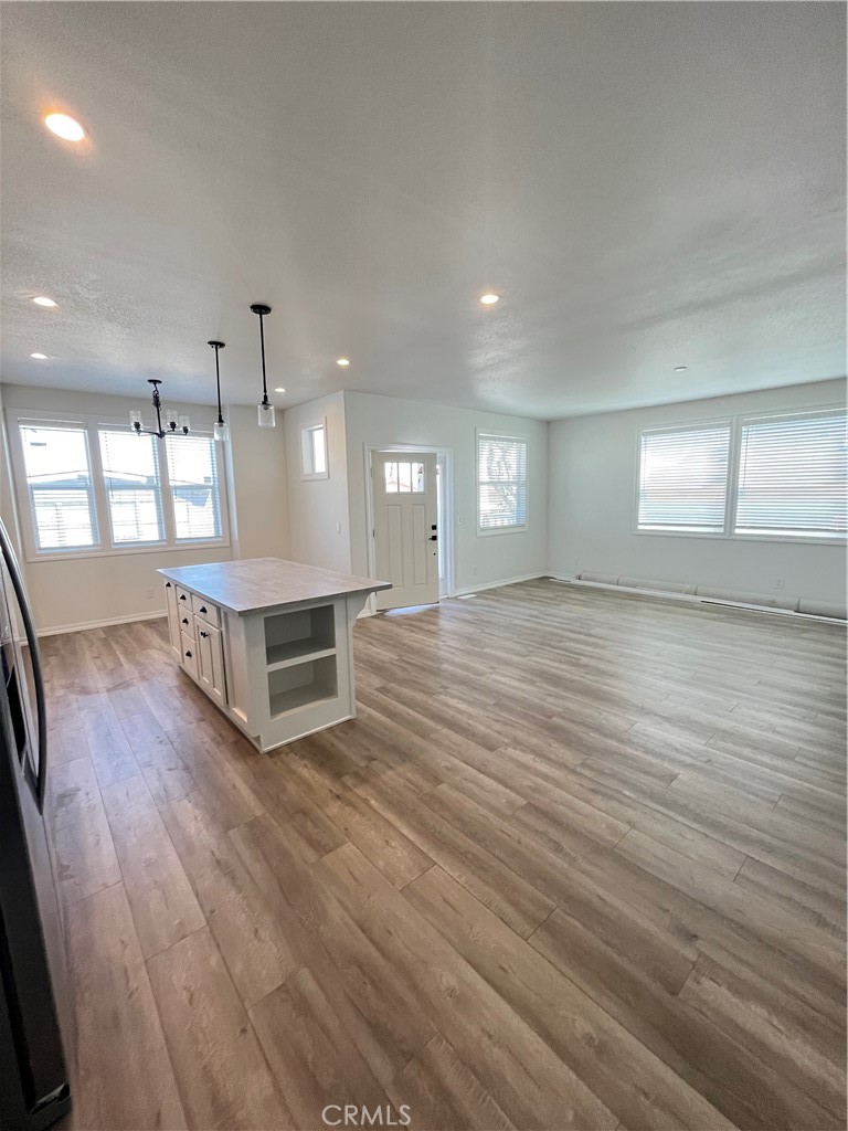 1550 Rimpau Avenue, Unit 42 Corona, CA 92881 - Photo 3 of 22 an empty room with wooden floor and windows