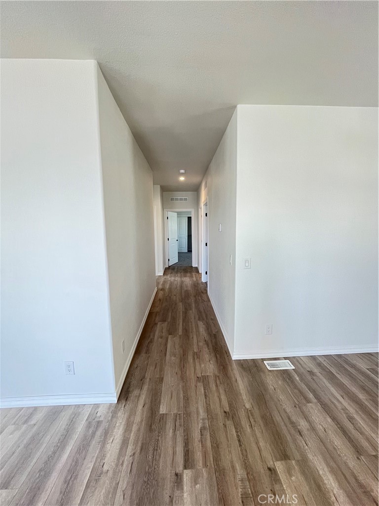 1550 Rimpau Avenue, Unit 42 Corona, CA 92881 - Photo 8 of 22 a view of a hallway with wooden floor