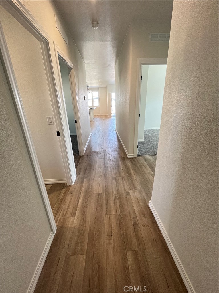 1550 Rimpau Avenue, Unit 42 Corona, CA 92881 - Photo 9 of 22 a view of a room with wooden floor and staircase