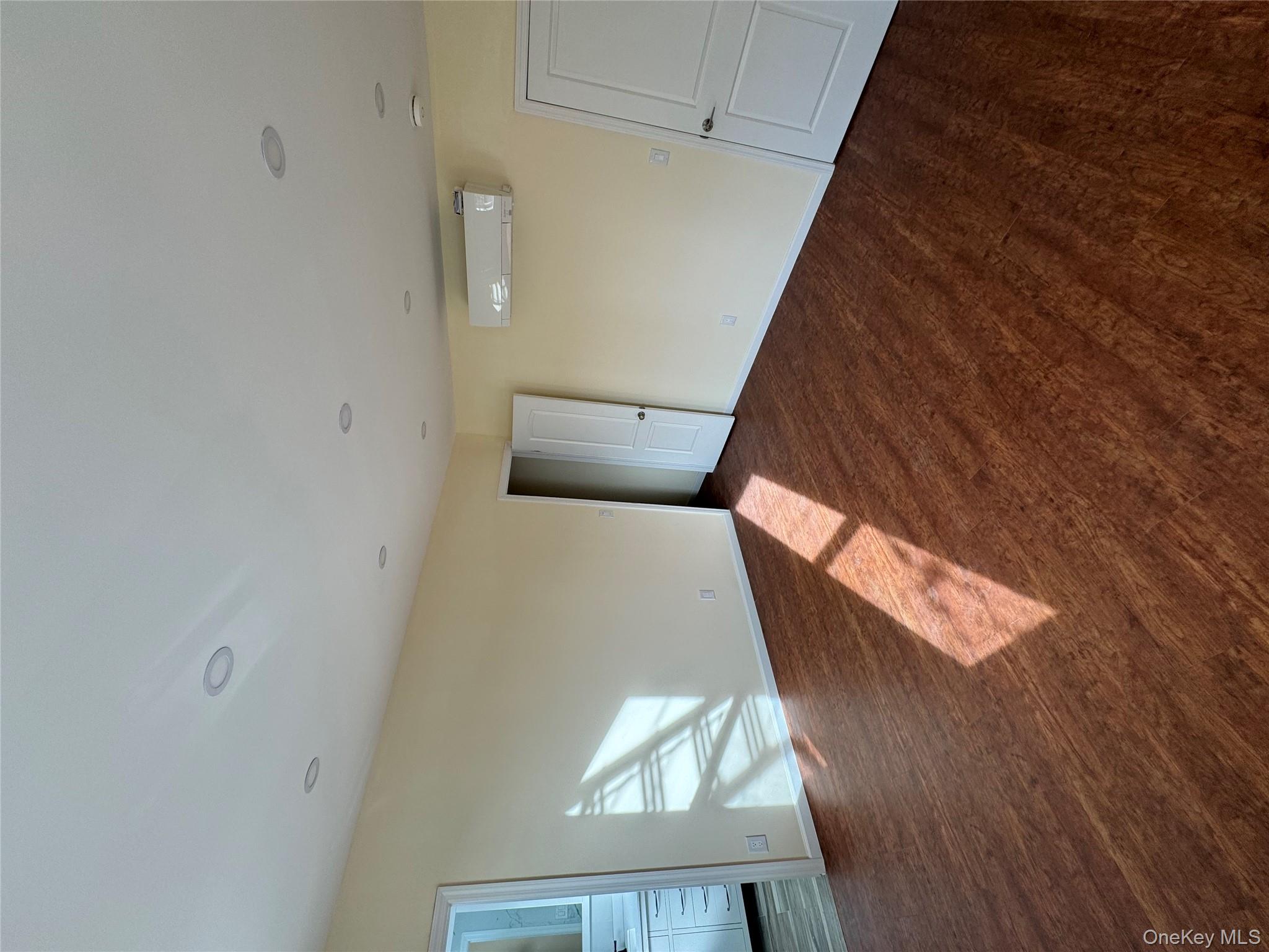 60-03 56th Road, Unit 2 Queens, NY 11378 - Photo 2 of 12 a view of empty room with wooden floor