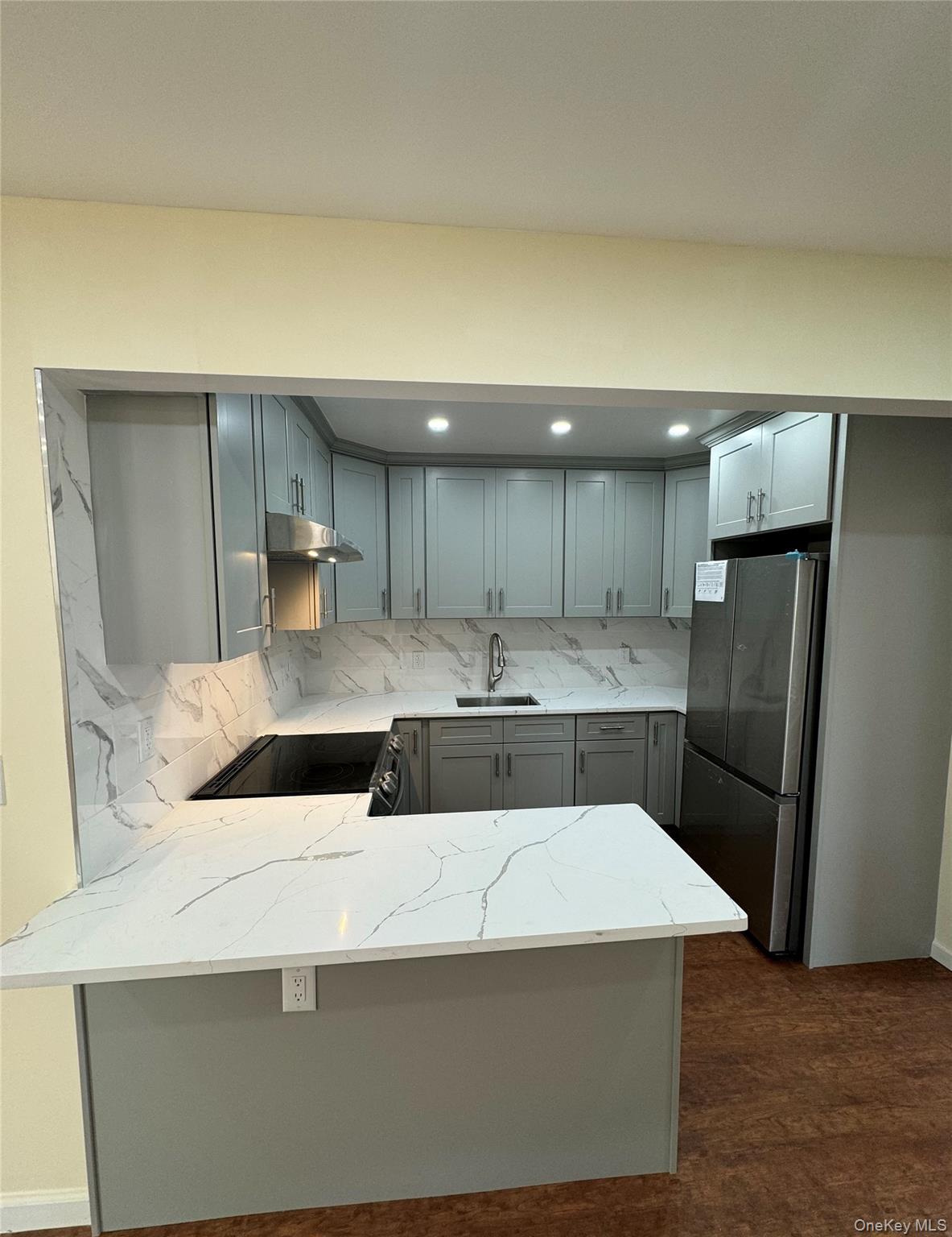 60-03 56th Road, Unit 2 Queens, NY 11378 - Photo 6 of 12 a large kitchen with a sink a refrigerator and a stove top oven