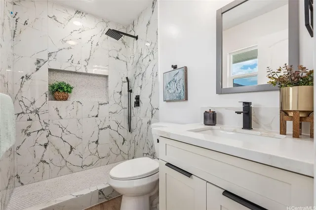 a bathroom with a sink toilet and shower