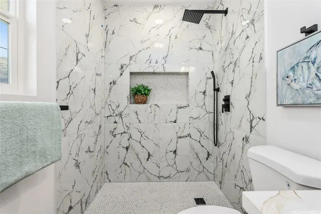 a bathroom with a toilet and a shower