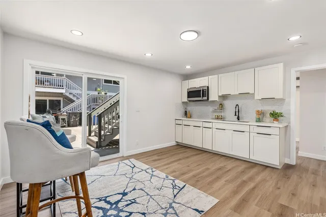 a kitchen with granite countertop a stove a sink and a refrigerator