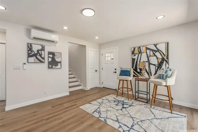 a view of a livingroom with furniture and a wooden floor