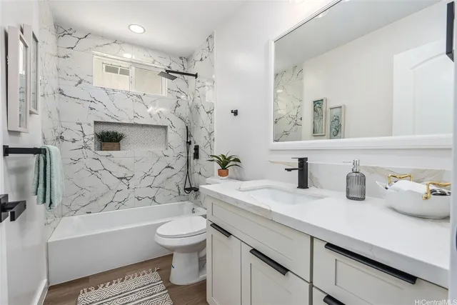 a bathroom with a sink a toilet and a bathtub