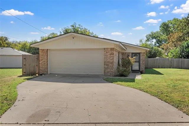 a front view of house with a garden