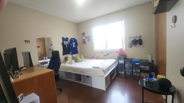 a bed room with a bed and a chair