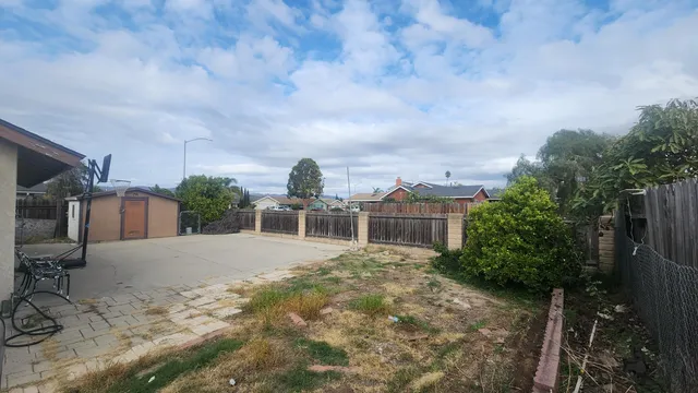 a view of backyard with roof deck and seating space
