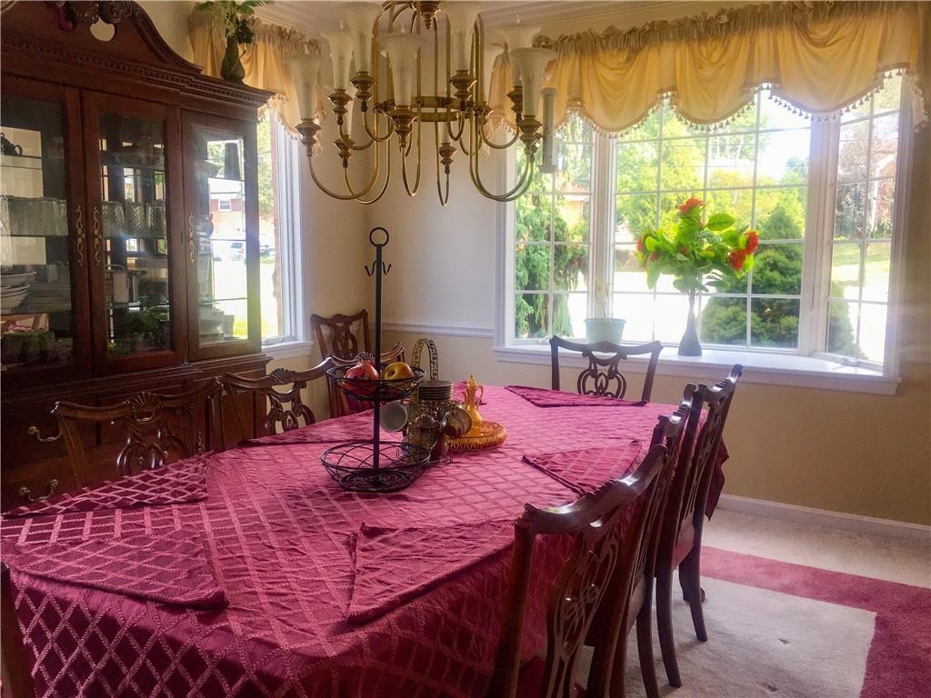 5076 Brownsville Road Pittsburgh, PA 15236 - Photo 13 of 50 a view of a dining room with furniture a chandelier and wooden floor