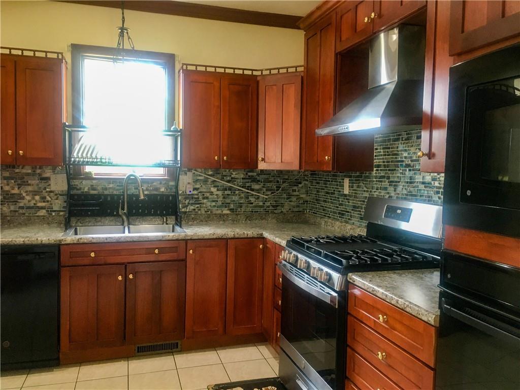 5076 Brownsville Road Pittsburgh, PA 15236 - Photo 20 of 50 a kitchen with granite countertop a stove and a sink