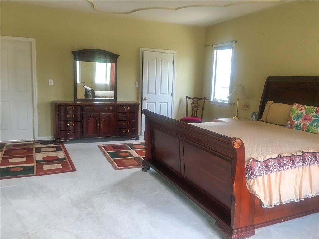 5076 Brownsville Road Pittsburgh, PA 15236 - Photo 24 of 50 a bedroom with a bed and a mirror