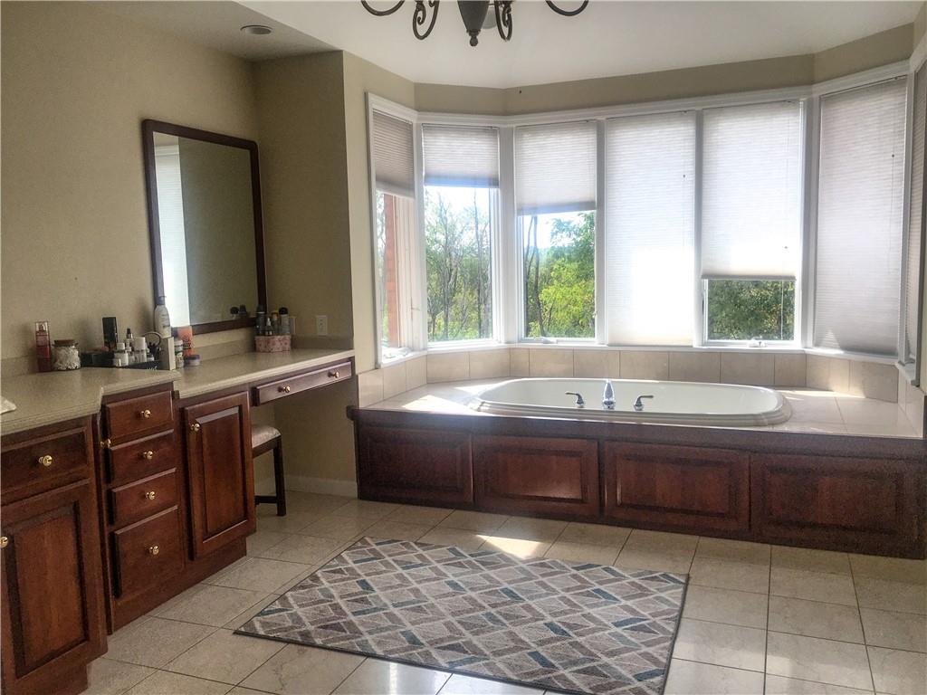 5076 Brownsville Road Pittsburgh, PA 15236 - Photo 26 of 50 a spacious bathroom with a tub sink and mirror