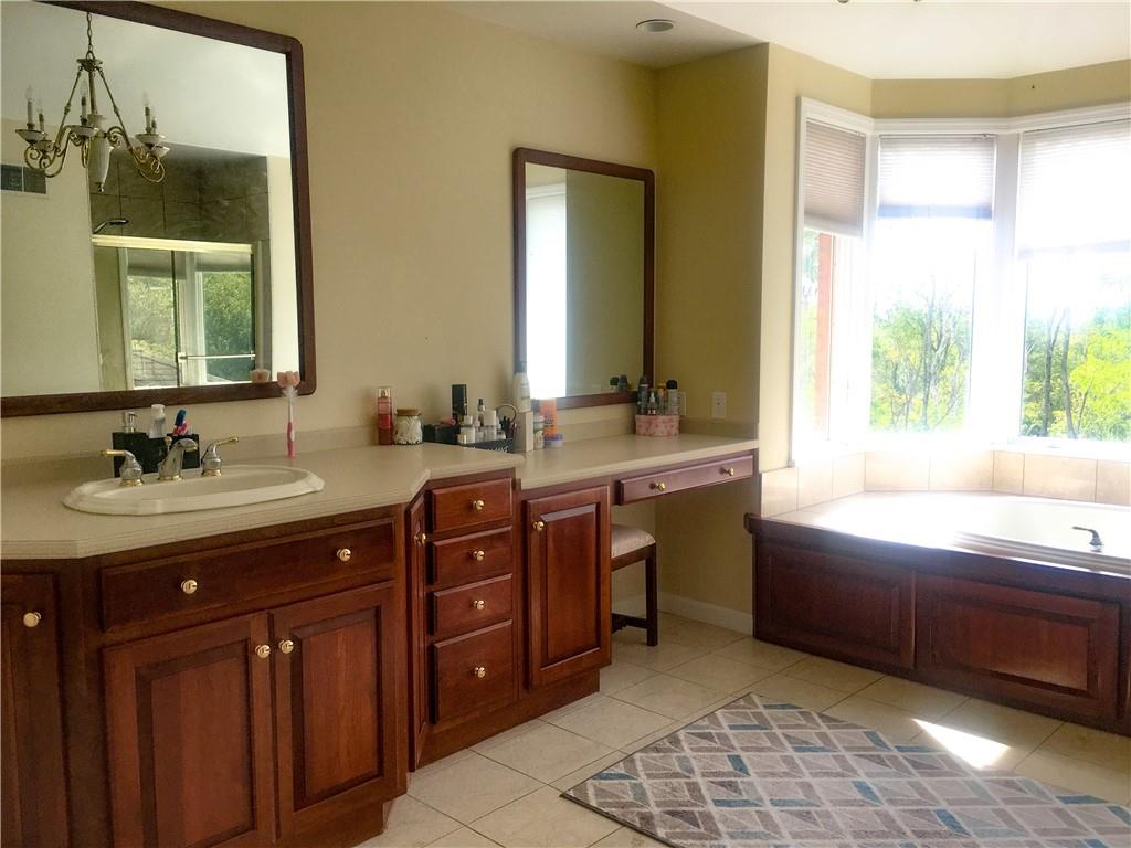 5076 Brownsville Road Pittsburgh, PA 15236 - Photo 27 of 50 a spacious bathroom with a tub sink and mirror