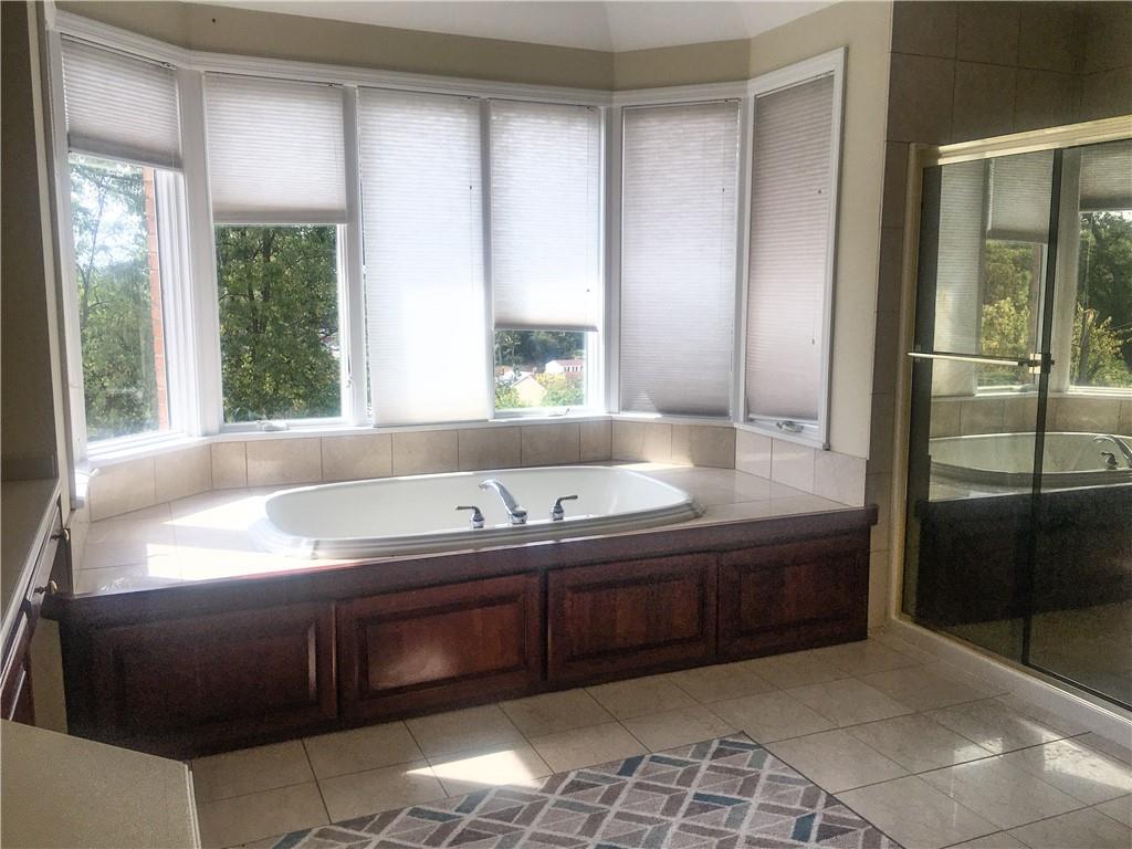 5076 Brownsville Road Pittsburgh, PA 15236 - Photo 28 of 50 a bathroom with a tub and a sink