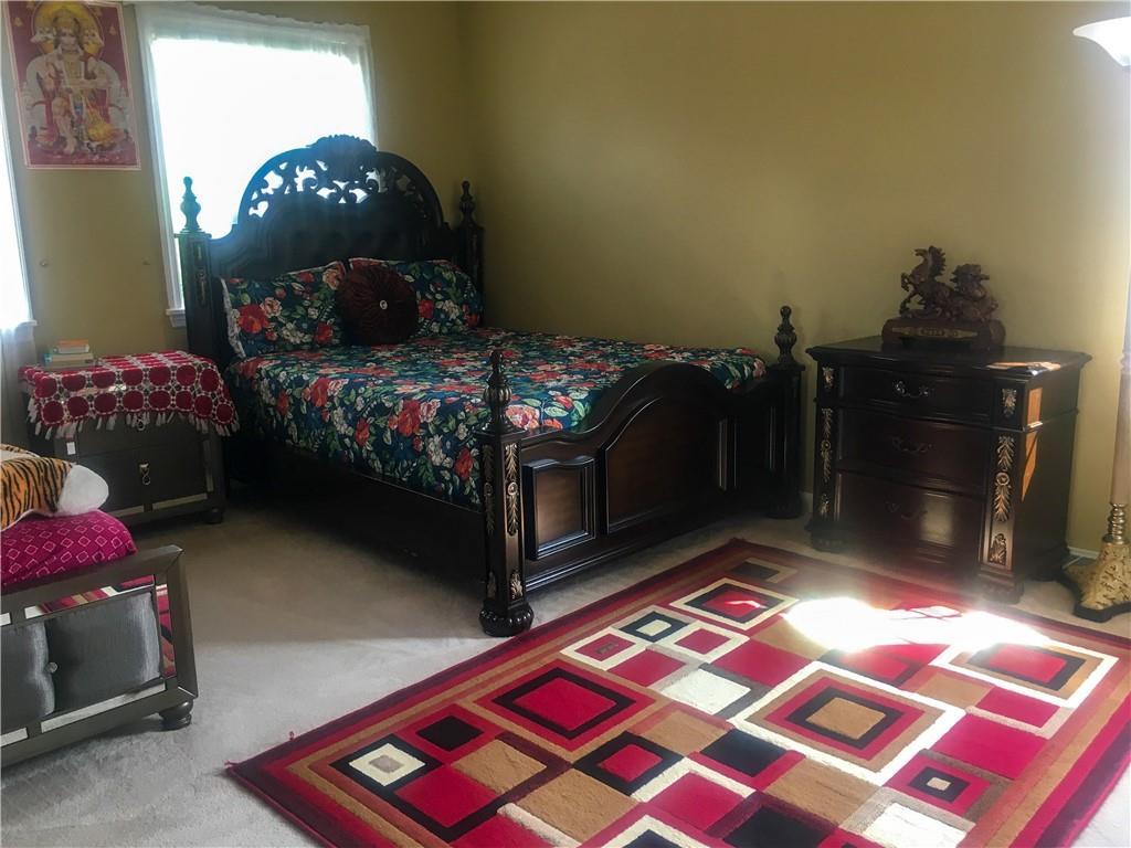 5076 Brownsville Road Pittsburgh, PA 15236 - Photo 30 of 50 a bedroom with a bed and a lamp