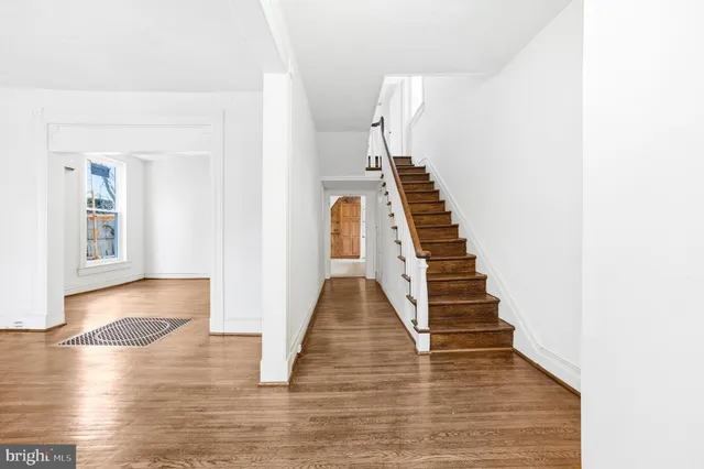 a view of entryway and hall with wooden floor