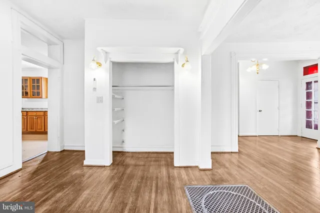 a view of empty room with wooden floor