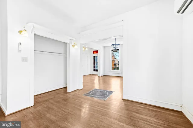 a view of empty room with wooden floor