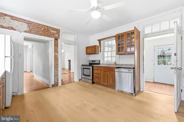 a kitchen with granite countertop a stove and a refrigerator