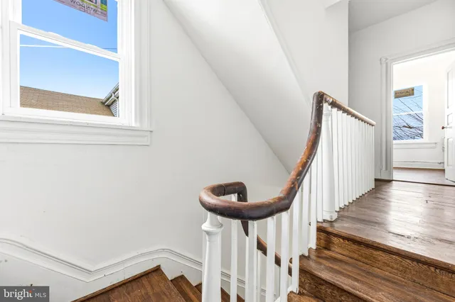 a view of entryway with wooden floor and stairs