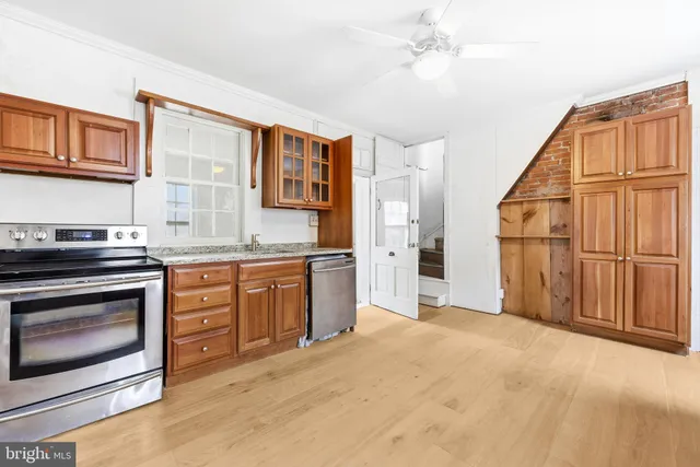 a kitchen with stainless steel appliances granite countertop a stove cabinets and microwave