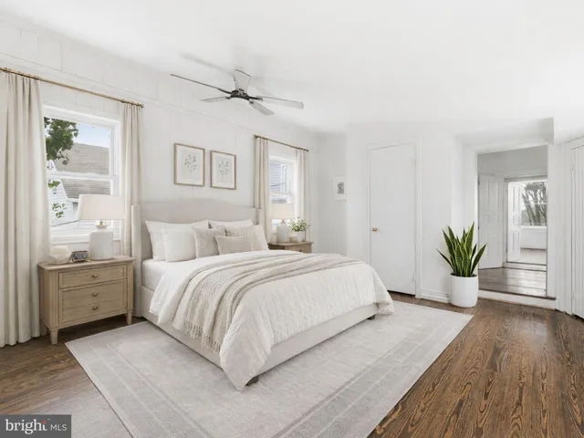 a spacious bedroom with a large bed and a chandelier