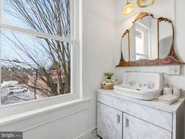 a bathroom with a sink a mirror and vanity