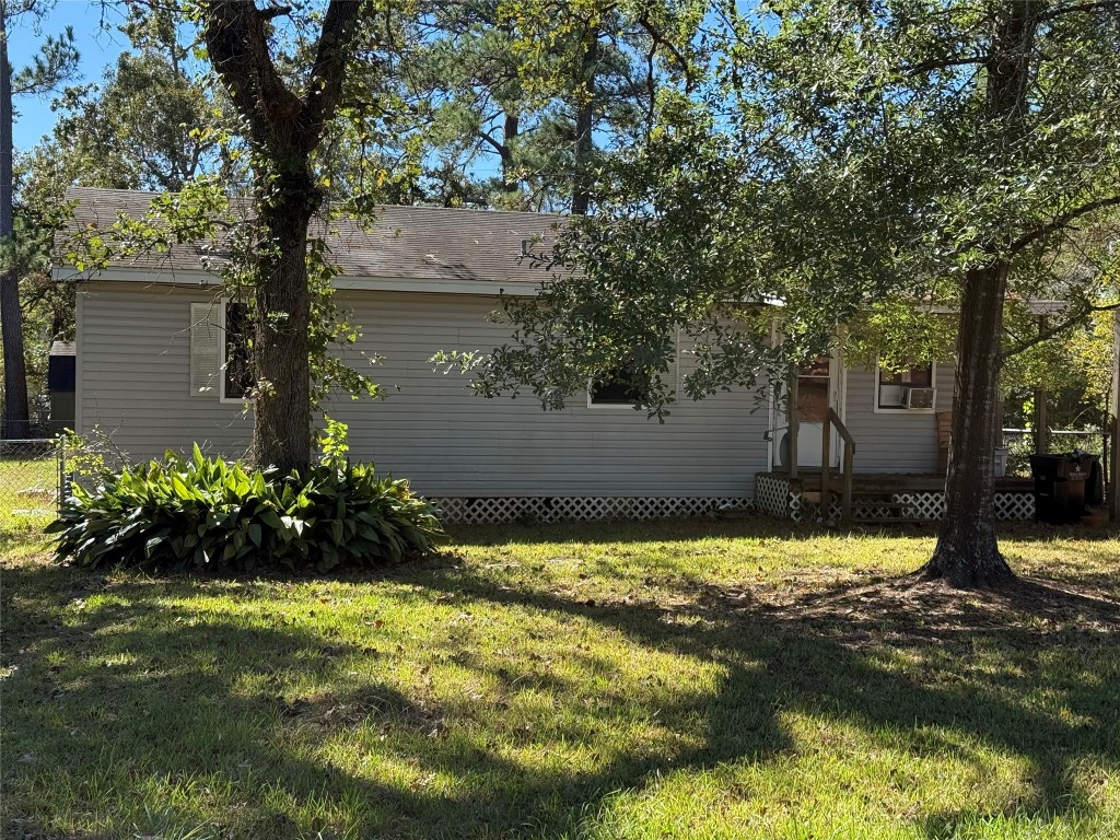a view of a house with a yard swimming pool and a large tree
