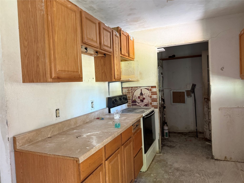 26457 Easy Street Magnolia, TX 77355 - Photo 4 of 15 a kitchen with stainless steel appliances granite countertop a sink stove and refrigerator