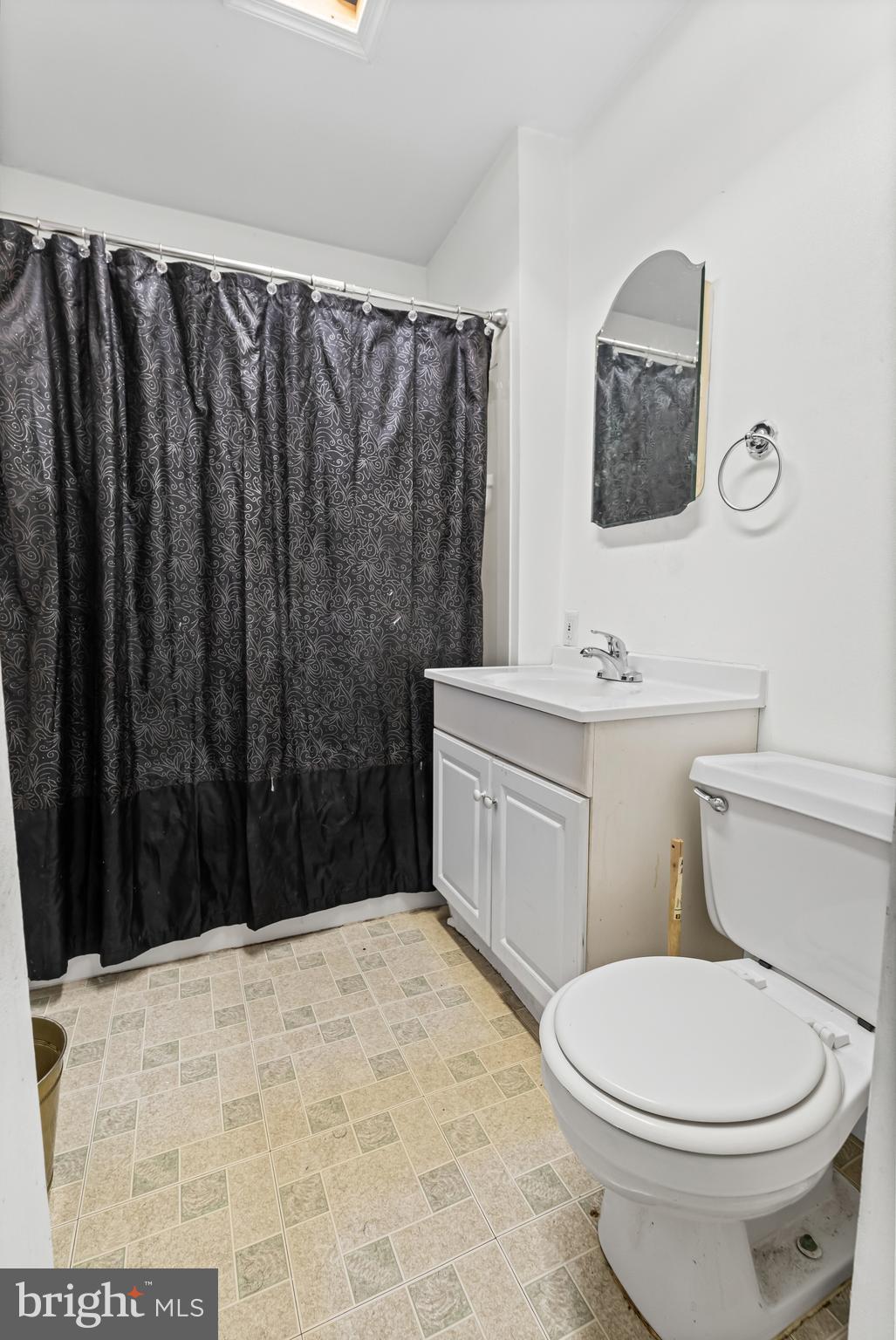 3804 Ridgecroft Road Baltimore, MD 21206 - Photo 12 of 21 a bathroom with a toilet a sink and a mirror