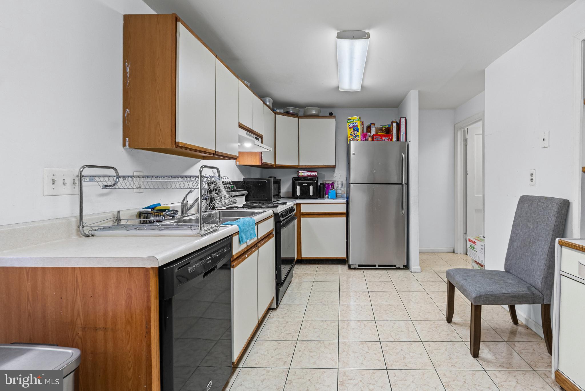 3804 Ridgecroft Road Baltimore, MD 21206 - Photo 7 of 23 a kitchen with a sink a refrigerator and cabinets