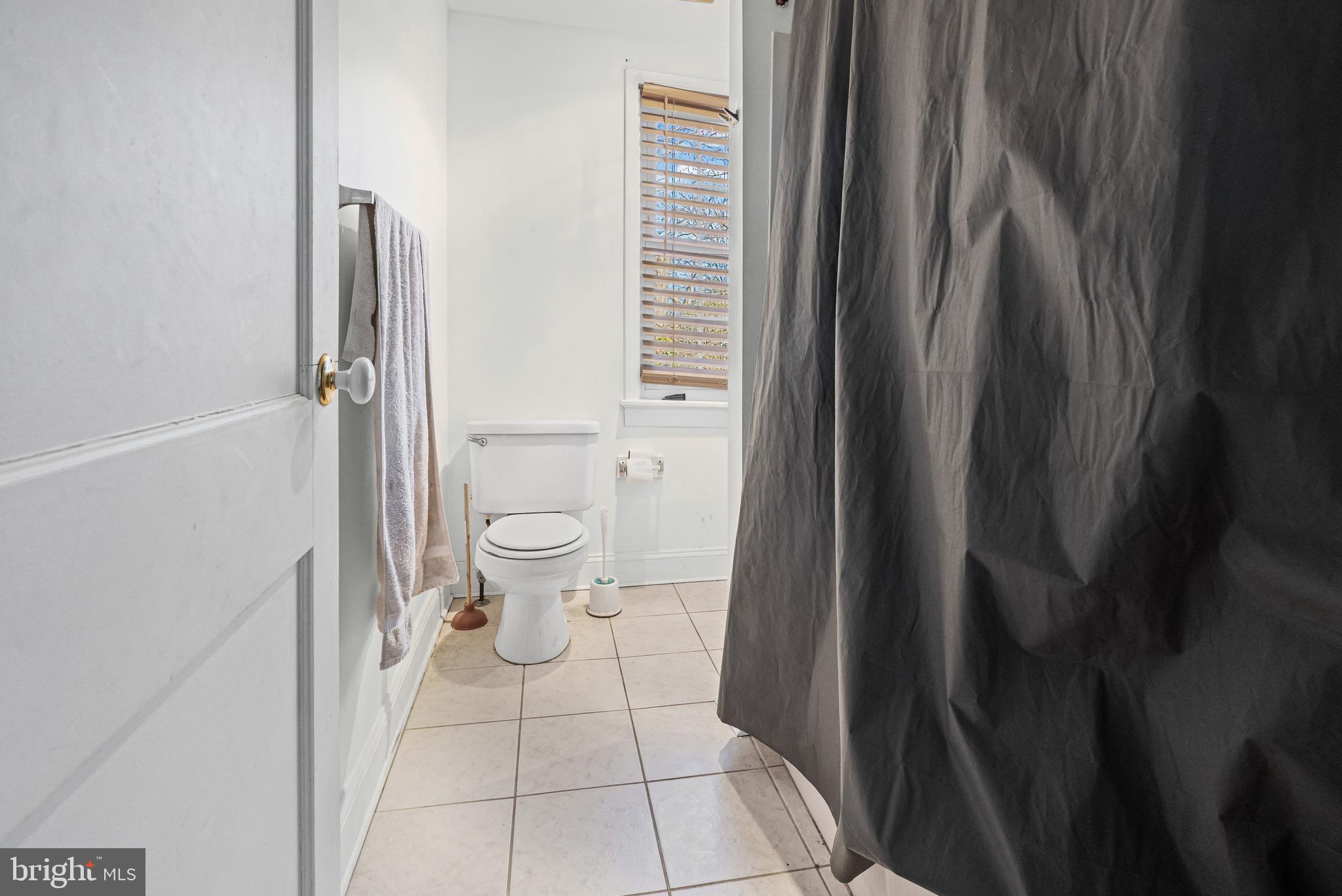 3804 Ridgecroft Road Baltimore, MD 21206 - Photo 8 of 23 a bathroom with a toilet and a shower