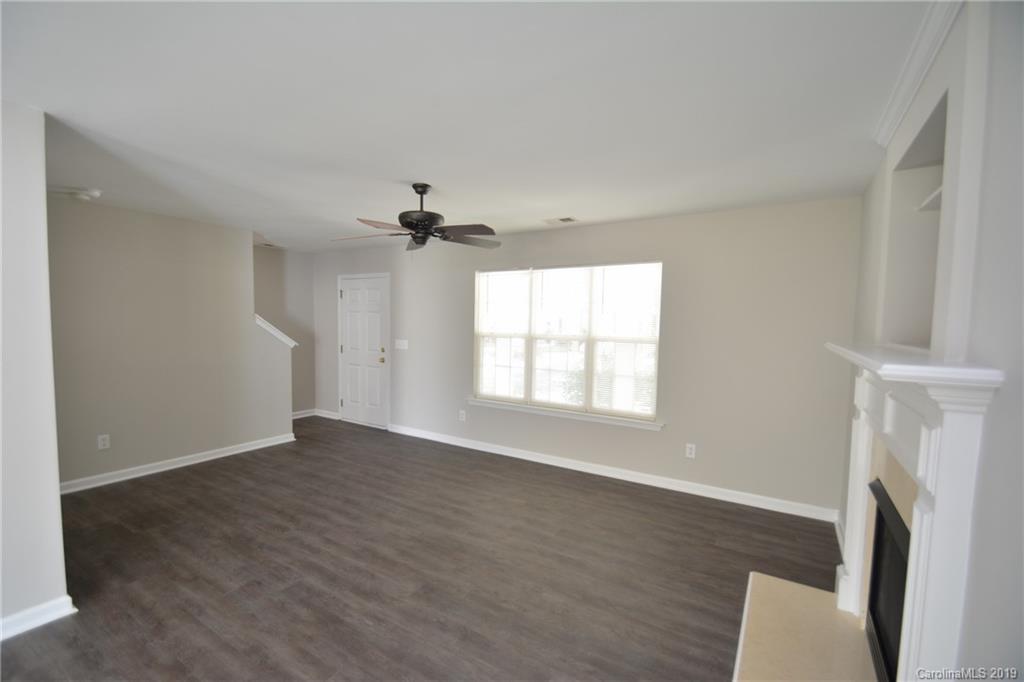 10044 Caldwell Depot Road Cornelius, NC 28031 - Photo 4 of 16 a view of empty room with wooden floor and fan