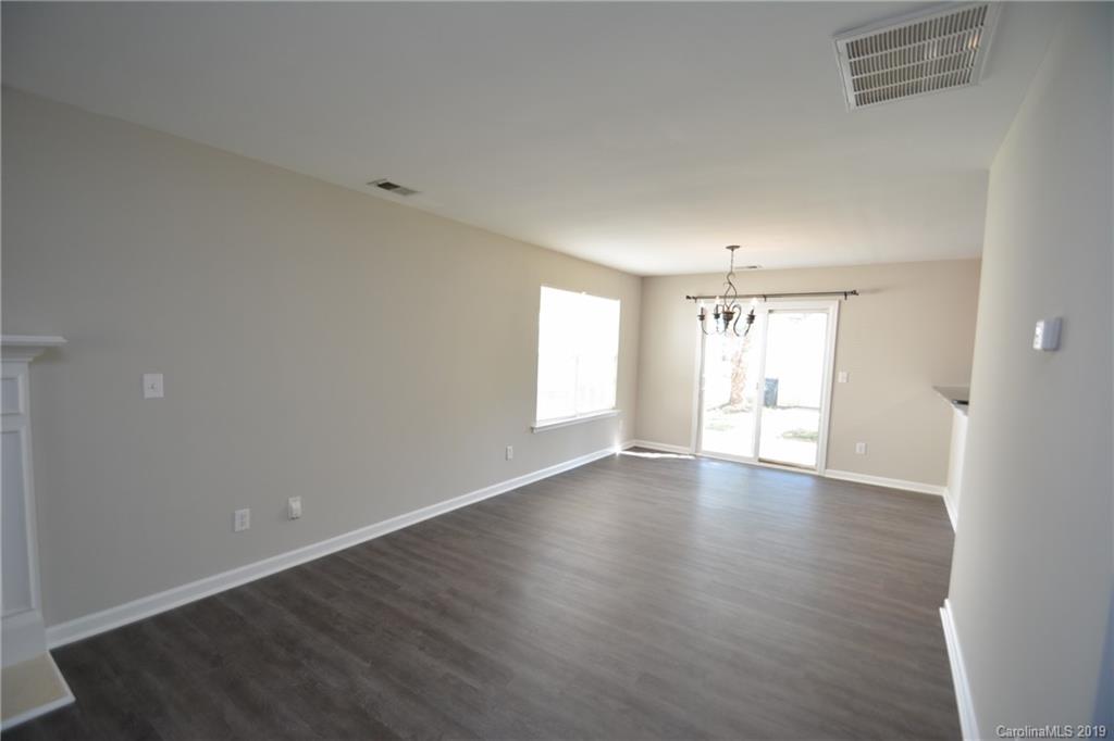 10044 Caldwell Depot Road Cornelius, NC 28031 - Photo 5 of 16 a view of an empty room with wooden floor and window